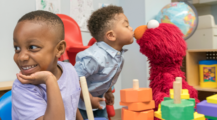 Elmo in a classroom with kids.