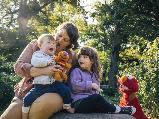 Elmo and a family in the park.