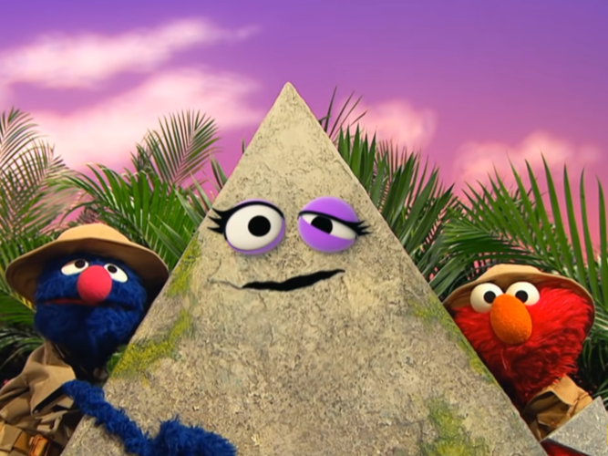 Grover and Elmo hugging a pyramid.