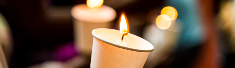 Multiple candles lit depicting a vigil.